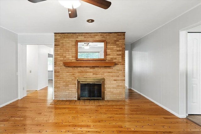 13105 Dartagnan Ct, Creve Coeur, MO 63141 - unfurnished living room with ceiling fan, wood-type flooring, a fireplace, baseboards, and ornamental molding