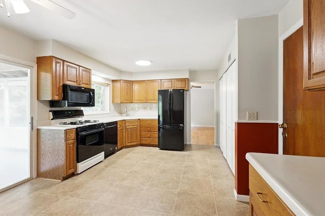 13105 Dartagnan Ct, Creve Coeur, MO 63141 - kitchen featuring black appliances, light countertops, a ceiling fan, and brown cabinetry