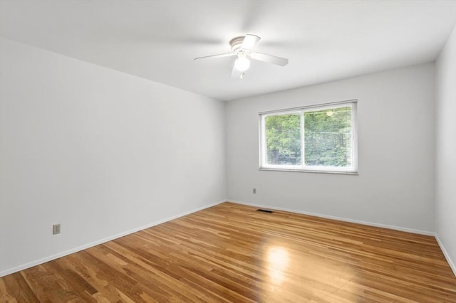 13105 Dartagnan Ct, Creve Coeur, MO 63141 - unfurnished room with wood finished floors, a ceiling fan, and baseboards