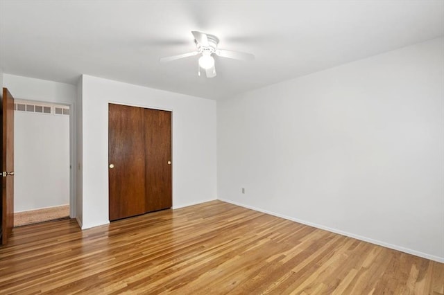 13105 Dartagnan Ct, Creve Coeur, MO 63141 - unfurnished bedroom with light wood-type flooring, a closet, ceiling fan, and baseboards