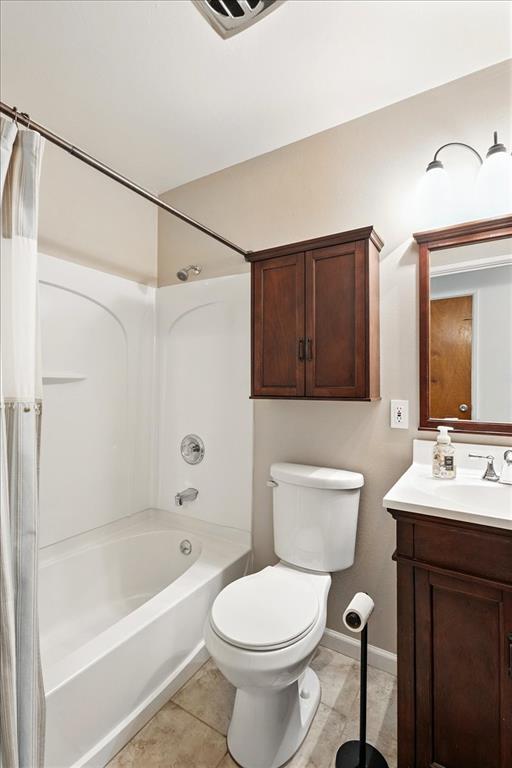 13105 Dartagnan Ct, Creve Coeur, MO 63141 - full bathroom featuring vanity, shower / bath combination with curtain, toilet, tile patterned floors, and baseboards