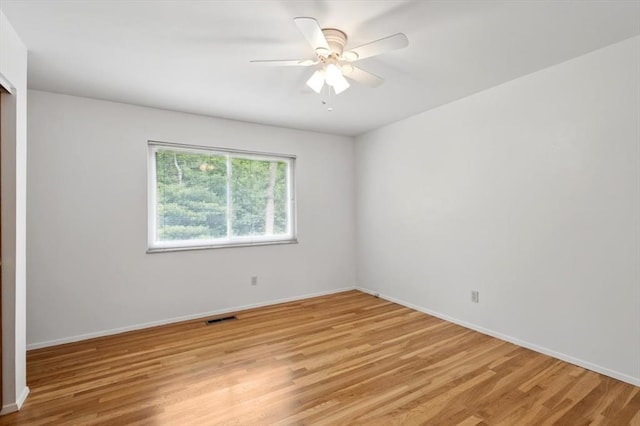13105 Dartagnan Ct, Creve Coeur, MO 63141 - empty room with light wood finished floors, baseboards, and ceiling fan