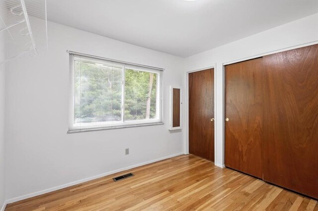 13105 Dartagnan Ct, Creve Coeur, MO 63141 - unfurnished bedroom featuring two closets, light wood-style floors, and baseboards