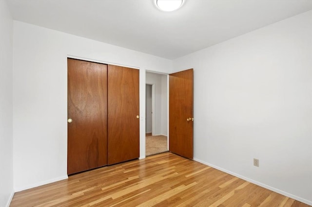 13105 Dartagnan Ct, Creve Coeur, MO 63141 - unfurnished bedroom featuring light wood-style floors, a closet, and baseboards