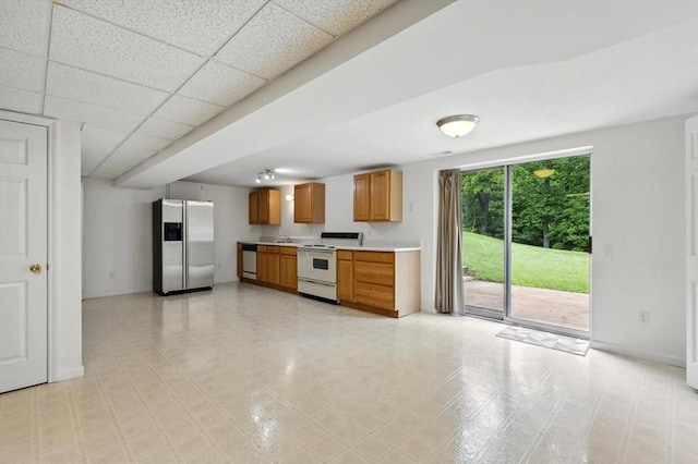13105 Dartagnan Ct, Creve Coeur, MO 63141 - kitchen featuring stainless steel appliances, light countertops, baseboards, brown cabinets, and a sink