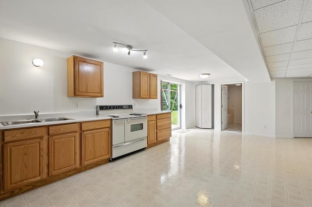 13105 Dartagnan Ct, Creve Coeur, MO 63141 - kitchen featuring white electric range oven, a sink, light countertops, and brown cabinetry