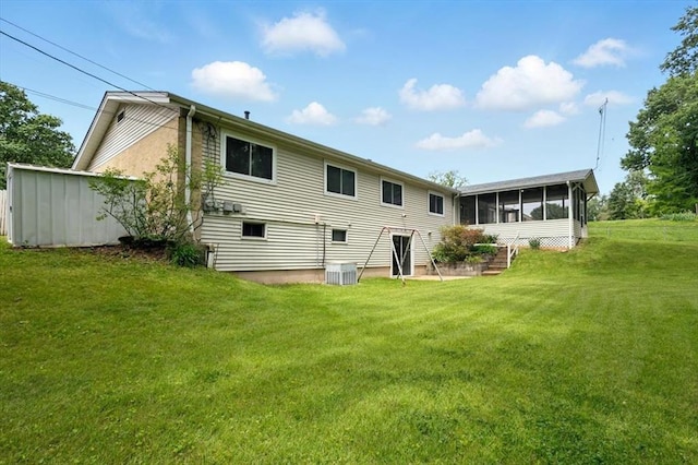 13105 Dartagnan Ct, Creve Coeur, MO 63141 - rear view of property with a sunroom, a lawn, and cooling unit