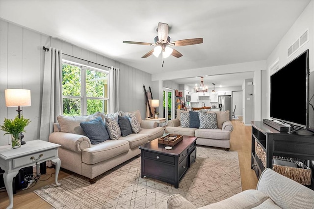 614 Oak Path Dr, Saint Louis, MO 63011 - living room with a ceiling fan, light wood-style floors, and a chandelier