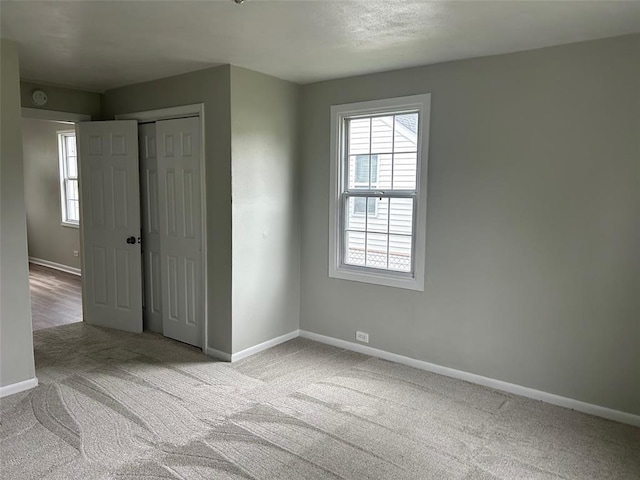 1910 E B St E, Belleville, IL 62221 - unfurnished bedroom with carpet floors, baseboards, and a closet