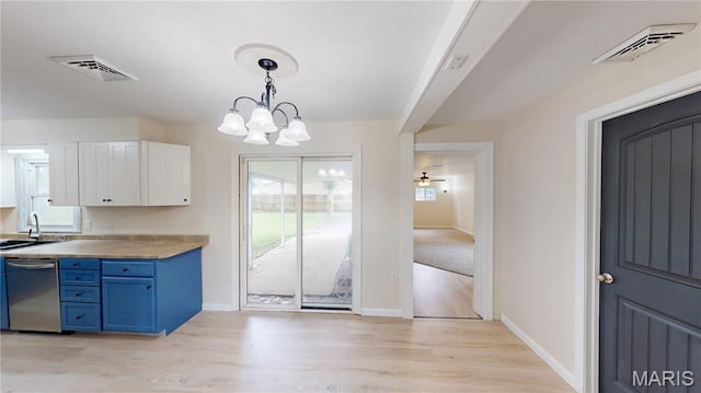 1350 Norwood Dr, Granite City, IL 62040 - kitchen with stainless steel dishwasher, blue cabinetry, white cabinetry, a chandelier, and light wood-style flooring