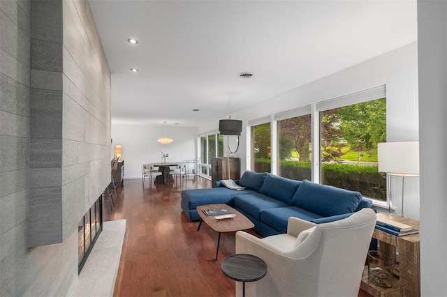 36 Stoneyside Ln, Olivette, MO 63132 - living area with wood finished floors, a tiled fireplace, healthy amount of natural light, and recessed lighting