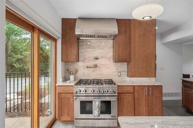 36 Stoneyside Ln, Olivette, MO 63132 - kitchen with high end range, wall chimney range hood, backsplash, and wood finished floors