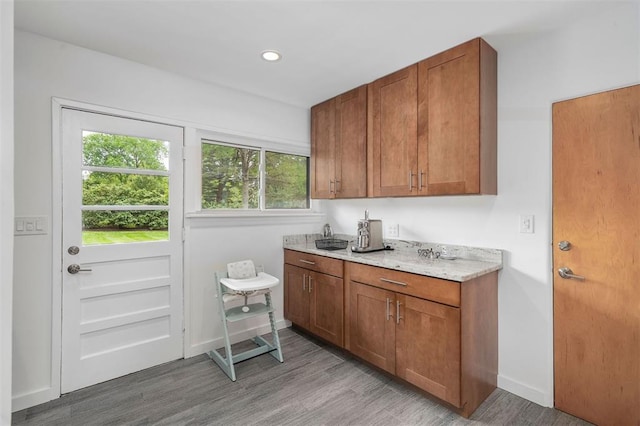 36 Stoneyside Ln, Olivette, MO 63132 - kitchen with brown cabinetry, light wood-type flooring, baseboards, and recessed lighting