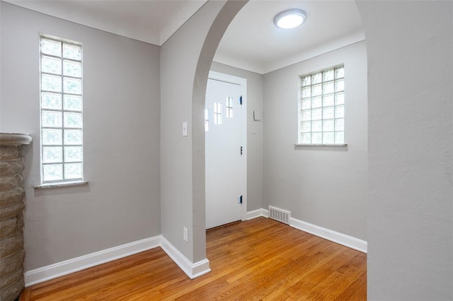 3210 Capehart Dr, Saint Louis, MO 63121 - foyer with arched walkways, light wood-style floors, plenty of natural light, and baseboards