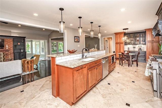 23 Vouga Ln, Frontenac, MO 63131 - kitchen featuring a sink, stainless steel appliances, a large island, recessed lighting, and brown cabinets