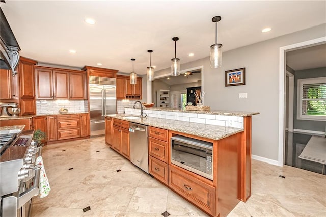 23 Vouga Ln, Frontenac, MO 63131 - kitchen featuring built in appliances, a sink, brown cabinetry, decorative backsplash, and recessed lighting
