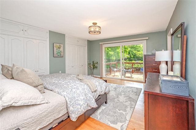 23 Vouga Ln, Frontenac, MO 63131 - bedroom with access to outside, wood finished floors, and two closets