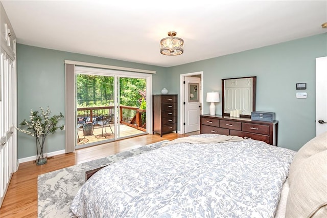 23 Vouga Ln, Frontenac, MO 63131 - bedroom with access to outside, light wood-type flooring, and baseboards