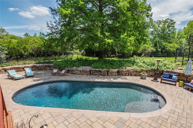 23 Vouga Ln, Frontenac, MO 63131 - view of pool featuring a patio area, a fenced backyard, and view of wooded area