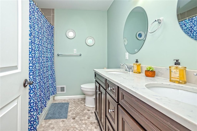 23 Vouga Ln, Frontenac, MO 63131 - full bath with double vanity, toilet, baseboards, and a shower with shower curtain