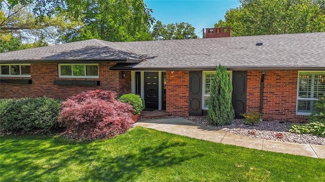 23 Vouga Ln, Frontenac, MO 63131 - ranch-style home featuring a shingled roof, brick siding, a chimney, and a front lawn