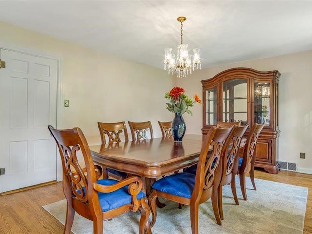 211 Country Club Ln, Belleville, IL 62223 - dining area featuring a chandelier and light wood-style floors