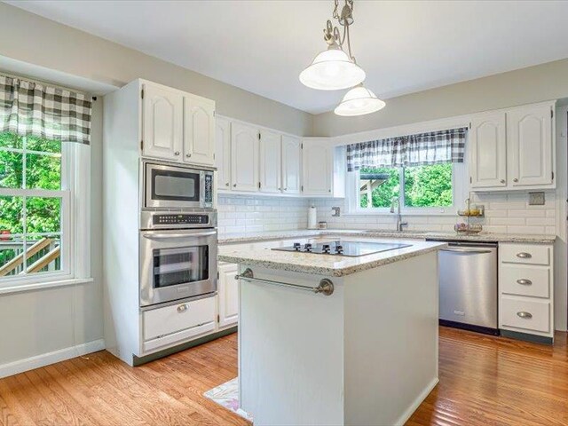 211 Country Club Ln, Belleville, IL 62223 - kitchen with appliances with stainless steel finishes, a sink, white cabinetry, backsplash, and light stone countertops