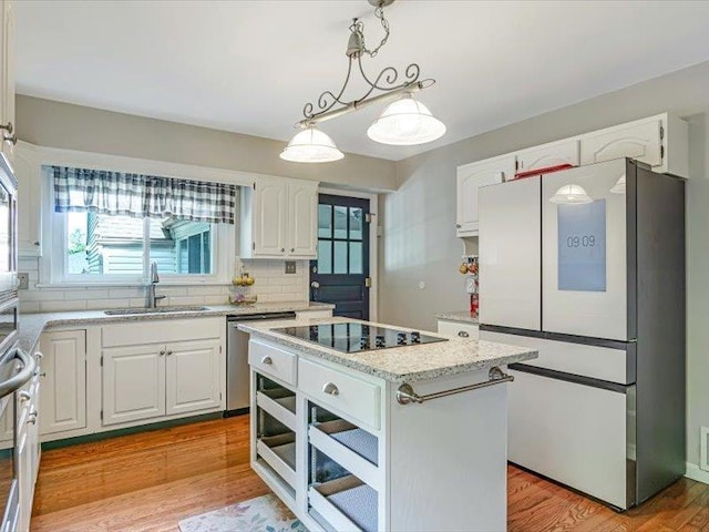 211 Country Club Ln, Belleville, IL 62223 - kitchen featuring freestanding refrigerator, a sink, stainless steel dishwasher, white cabinets, and backsplash