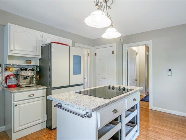 211 Country Club Ln, Belleville, IL 62223 - kitchen featuring black electric cooktop, freestanding refrigerator, white cabinets, light wood finished floors, and baseboards