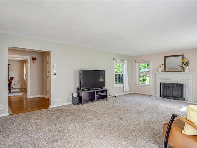 211 Country Club Ln, Belleville, IL 62223 - unfurnished living room featuring carpet floors, baseboards, and a fireplace with flush hearth