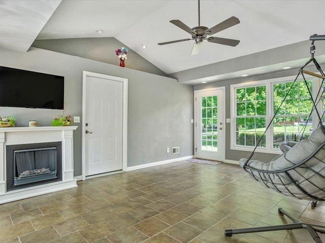 211 Country Club Ln, Belleville, IL 62223 - unfurnished living room featuring lofted ceiling, baseboards, a ceiling fan, a fireplace with raised hearth, and stone finish flooring