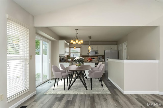 403 Autumn Farms Ct, Wentzville, MO 63385 - dining area featuring a chandelier and wood finished floors