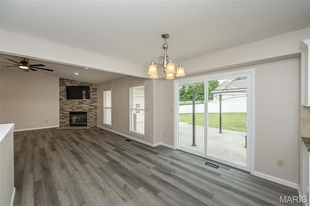 403 Autumn Farms Ct, Wentzville, MO 63385 - unfurnished living room with wood finished floors, vaulted ceiling, a chandelier, a fireplace, and ceiling fan