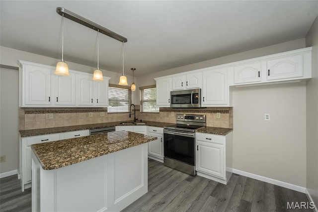 403 Autumn Farms Ct, Wentzville, MO 63385 - kitchen featuring appliances with stainless steel finishes, white cabinetry, and decorative backsplash