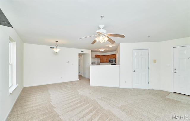 9 Homefield Gardens Dr Unit 31N, Ofallon, MO 63366 - unfurnished living room with ceiling fan, light colored carpet, and baseboards
