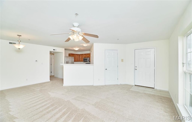 9 Homefield Gardens Dr Unit 31N, Ofallon, MO 63366 - unfurnished living room with light carpet, a ceiling fan, and baseboards