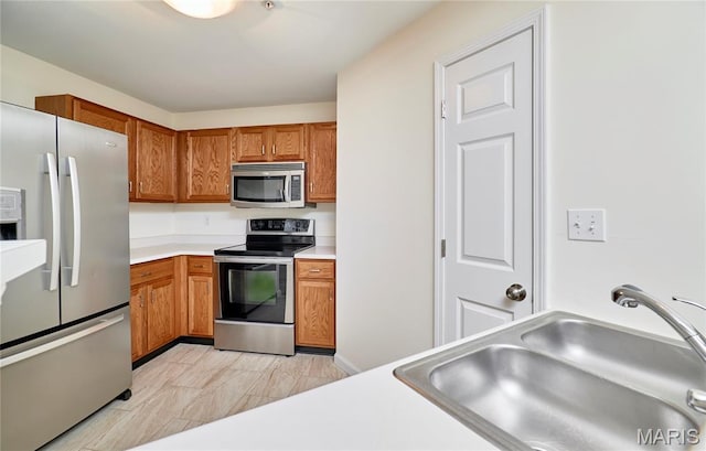 9 Homefield Gardens Dr Unit 31N, Ofallon, MO 63366 - kitchen with appliances with stainless steel finishes, a sink, brown cabinets, and light countertops