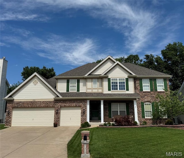 930 Bentley Park Cir, Ofallon, MO 63368 - view of front facade with driveway, a front yard, brick siding, and an attached garage