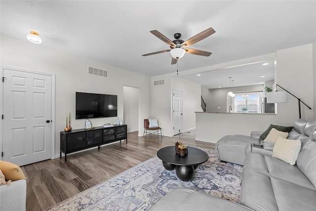 3516 Broad St, Saint Charles, MO 63301 - living area with wood finished floors, ceiling fan, baseboards, and stairs