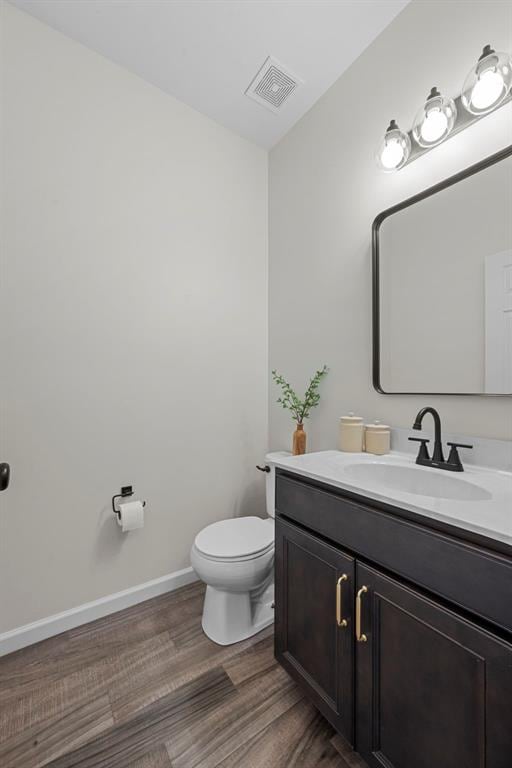3516 Broad St, Saint Charles, MO 63301 - bathroom with vanity, toilet, wood finished floors, and baseboards