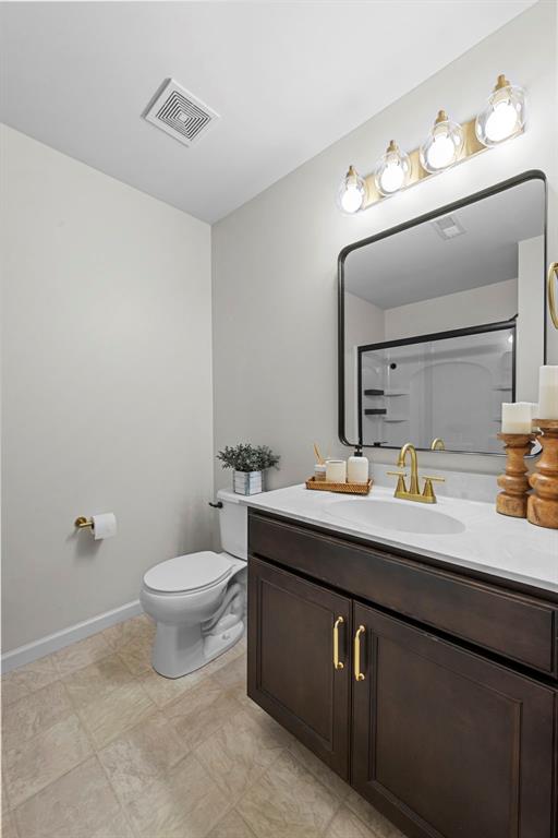 3516 Broad St, Saint Charles, MO 63301 - bathroom with vanity, toilet, and baseboards