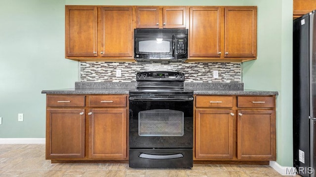 1101 Gulfstream Way, Mascoutah, IL 62258 - kitchen featuring black appliances, dark countertops, brown cabinetry, and backsplash