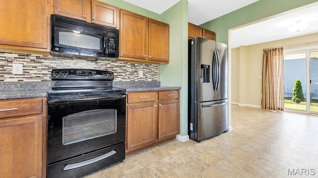 1101 Gulfstream Way, Mascoutah, IL 62258 - kitchen with black appliances, brown cabinetry, dark countertops, and tasteful backsplash