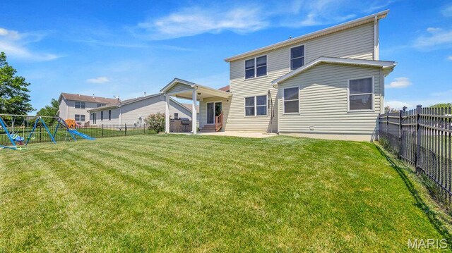 1101 Gulfstream Way, Mascoutah, IL 62258 - back of property featuring a patio area, a playground, and a fenced backyard