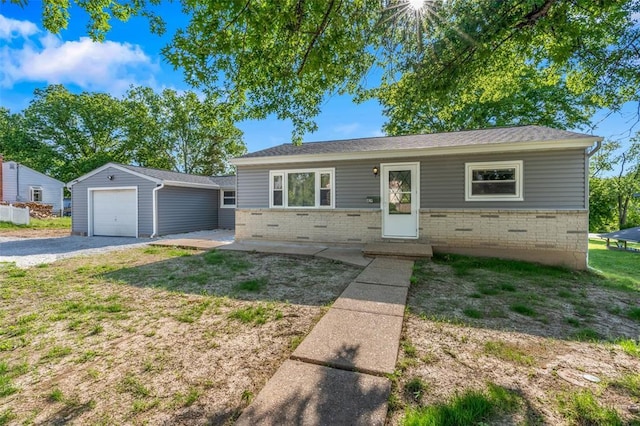 418 Williams St, Pacific, MO 63069 - view of front of home with an outbuilding, brick siding, driveway, and a garage