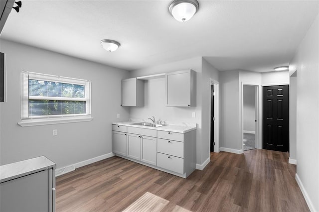 418 Williams St, Pacific, MO 63069 - kitchen with a sink, light countertops, wood finished floors, and baseboards