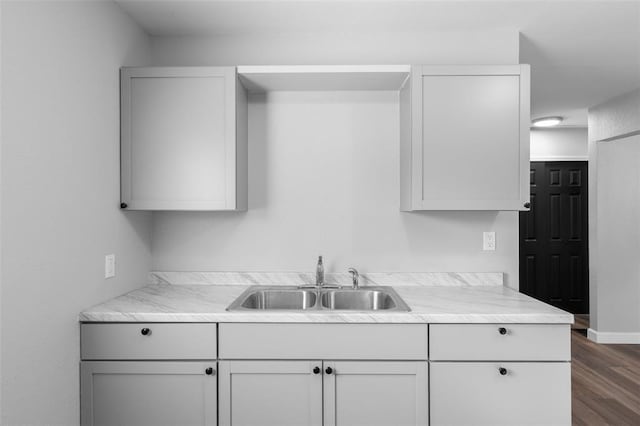 418 Williams St, Pacific, MO 63069 - kitchen featuring a sink, dark wood-style flooring, light countertops, and baseboards