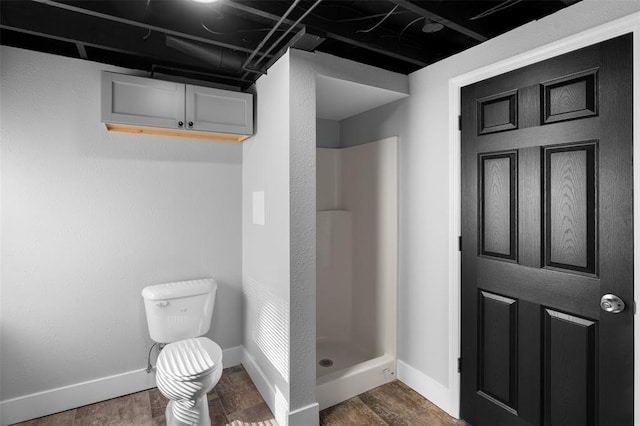 418 Williams St, Pacific, MO 63069 - bathroom with a stall shower, toilet, wood finished floors, and baseboards