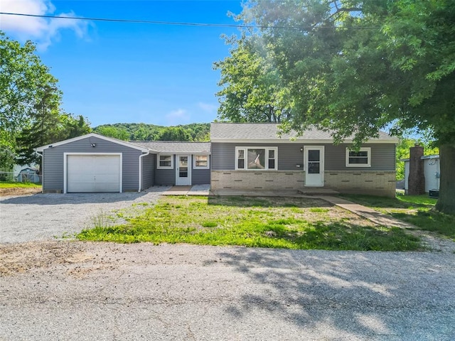 418 Williams St, Pacific, MO 63069 - ranch-style house with gravel driveway, an attached garage, and brick siding