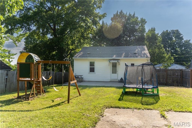 108 Tomlinson St, East Alton, IL 62024 - rear view of property with a trampoline, a playground, a patio, and a fenced backyard